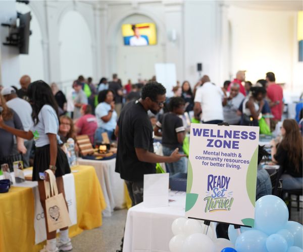 Resident requests information at mental health wellness celebration. 