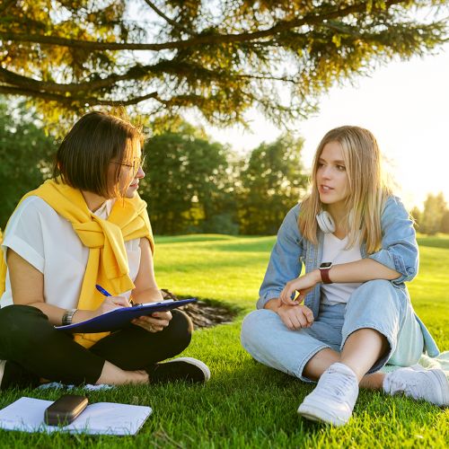 mental health therapist and client sitting in park